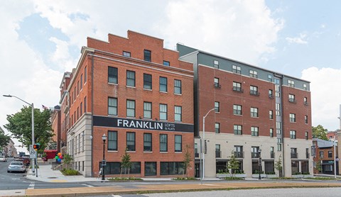 a large brick building on the corner of a street